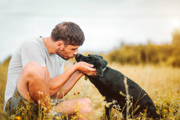 istock Guy and his dog having a fun in the nature 1165588776