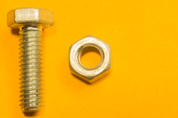 istock Steel screws on a yellow background 1165589168