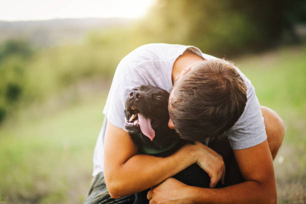 istock Guy and his dog having a fun in the nature 1165589891