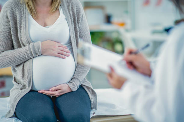 istock Pregnant woman at doctor's office 1165590057