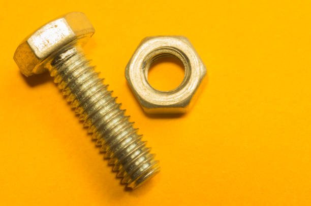 istock Steel screws on a yellow background 1165590389