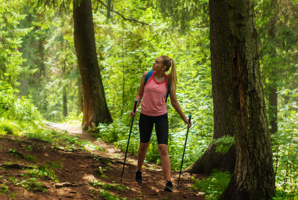istock young woman trekking in a mountain forest 1165590575