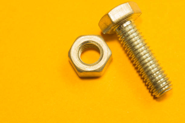 istock Steel screws on a yellow background 1165590638