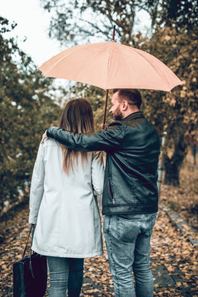 istock Couple Enjoying The Rain And Romantic Activity 1165591597