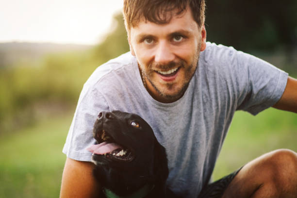 istock Guy and his dog having a fun in the nature 1165591636
