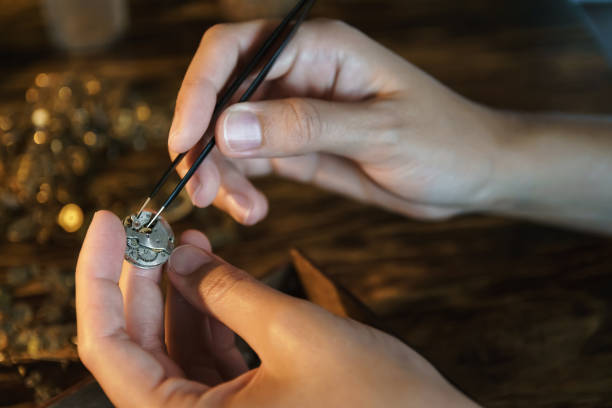 istock Craftsman dismantles clock and gets gears. 1165591861