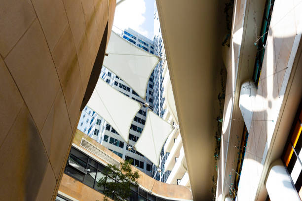 istock Low angle view of modern white sunshades between buildings, background with copy space 1165592930