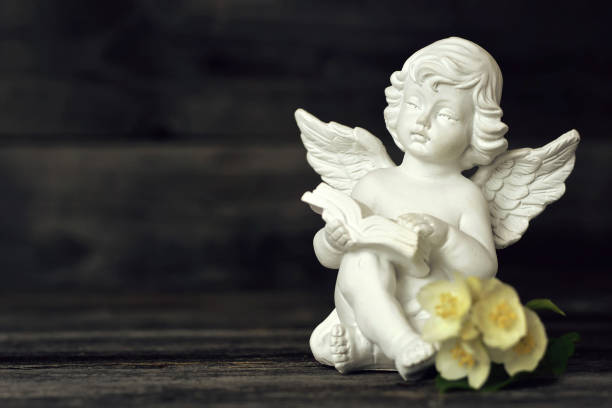 istock Little guardian angel reading a book 1165595390