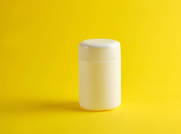 istock closed white plastic jar for medicines on a yellow background 1165595432