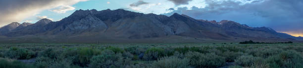 istock Panoramic view of mountain range colorful sunset with clouds before storm 1165595486