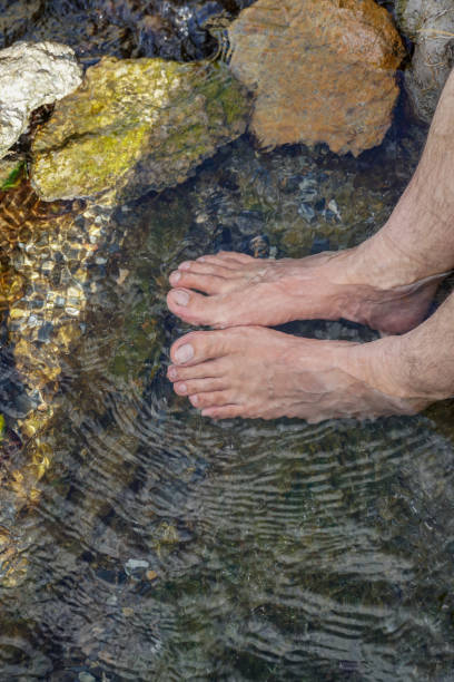 istock Feet immersed in the clear water of river 1165596338