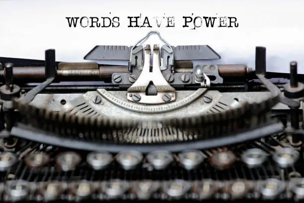 Text Words Have Power typed on retro typewriter