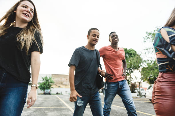 istock Group of college students walking on campus 1165598478