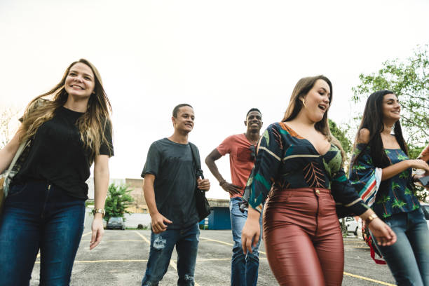 istock Group of college students walking on campus 1165598485