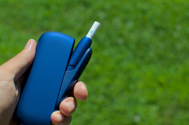 IQOS 3 electronic cigarette device with heat-not-burn system Caslano, Ticino, Switzerland - 26th July 2019 : Picture of the IQOS 3 version, a new heat-not-burn tobacco product technology produced by Philip Morris International in Neuchatel, Switzerland iqos e cig stock pictures, royalty-free photos & images