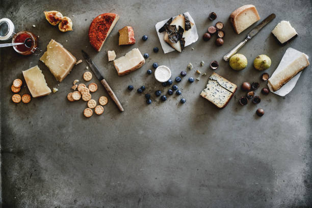 istock Variety of wine snacks, jam and cheeses over grey background 1165602679