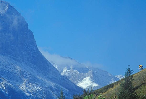 Clouds are pulling off of the distant snowcapped mountains, Alberta