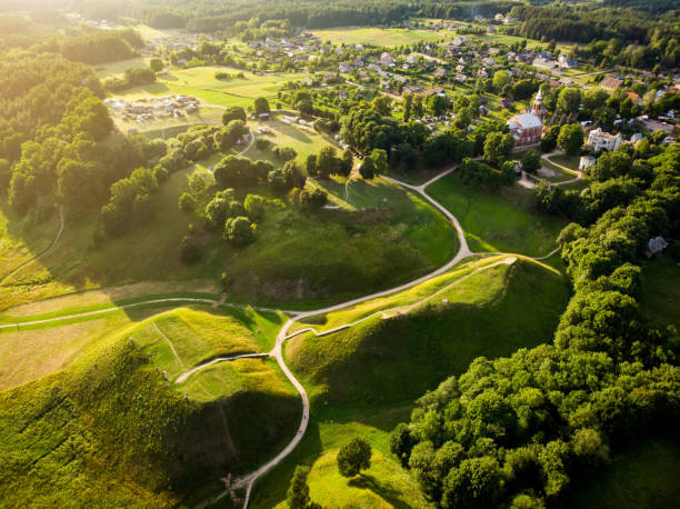Aerial view of Kernave Archaeological site, a medieval capital of the Grand Duchy of Lithuania, tourist attraction and UNESCO World Heritage Site. Aerial view of Kernave Archaeological site, a medieval capital of the Grand Duchy of Lithuania, tourist attraction and UNESCO World Heritage Site. Sunny summer evening. burial mound photos stock pictures, royalty-free photos & images