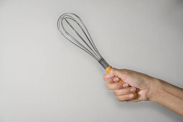 istock Woman holding whisk for beater. 1165610479
