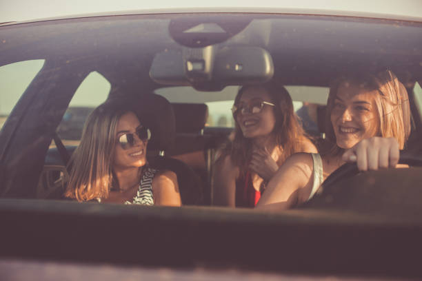istock Girlfriends driving together on a road trip 1165610666