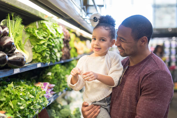 istock Dad grocery shopping with his daughter 1165611096