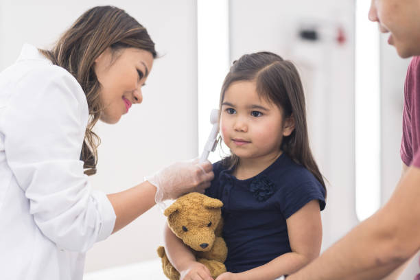 istock Young ethnic girl at the doctor's office getting a checkup 1165611198