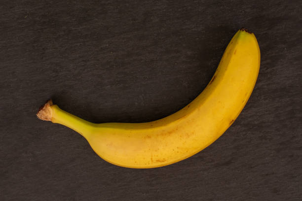 istock Ripe yellow banana on grey stone 1165613313