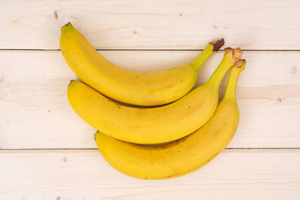 istock Ripe yellow banana on grey wood 1165613393