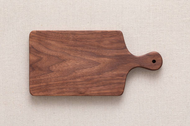 istock Walnut handmade wood cutting board on the linen 1165619785