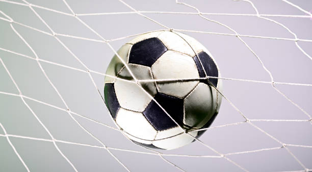 istock Soccer ball in the net 1165622430