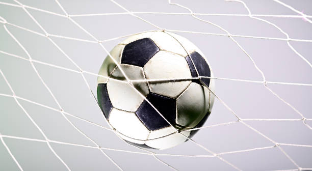istock Soccer ball in the net 1165622939