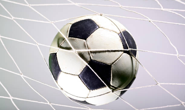 istock Soccer ball in the net 1165622991