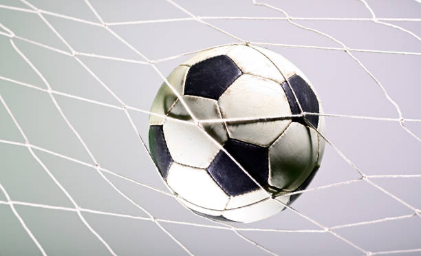 istock Soccer ball in the net 1165623026