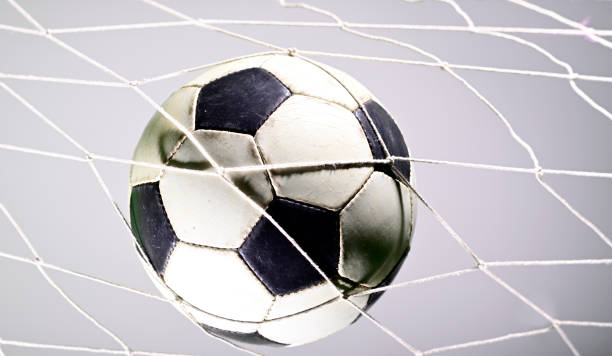 istock Soccer ball in the net 1165623039