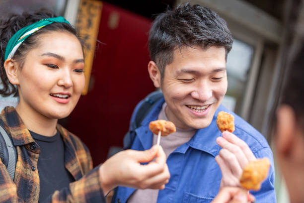 istock Friends Eating Take Away Chicken 1165627149