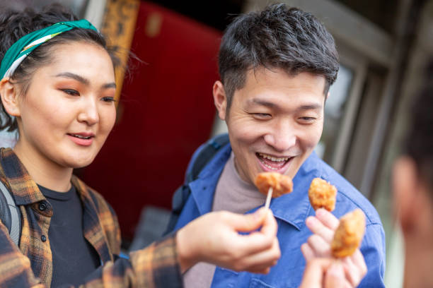 istock Friends Eating Take Away Chicken 1165627177