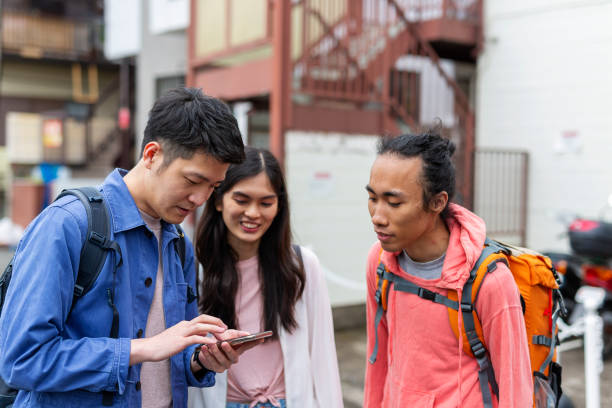 istock Group of Tourists Getting Directions From a Phone App 1165627181