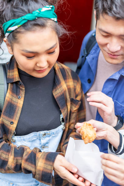 istock Friends Eating Take Away Chicken 1165627215
