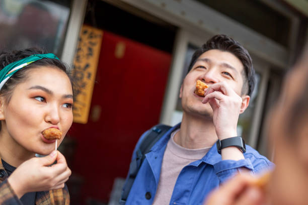 istock Friends Eating Take Away Chicken 1165627218