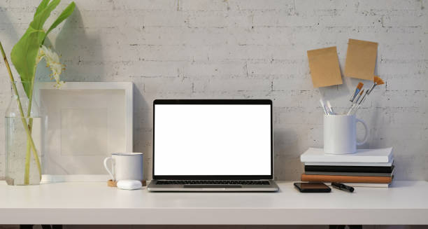 istock Open blank screen laptop with office supplies 1165627428
