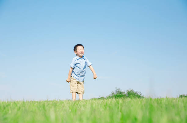istock Japanese boy playing in the field 1165627496