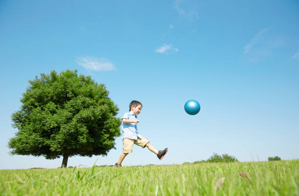 istock Japanese boy playing in the field 1165627539