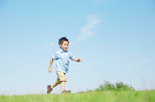 istock Japanese boy playing in the field 1165627542