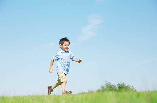 Japanese boy playing in the field