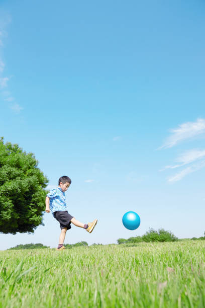 istock Japanese boy playing in the field 1165627552
