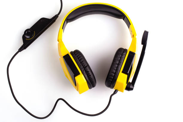 istock The yellow headphones with a microphone isolated on white background 1165628582
