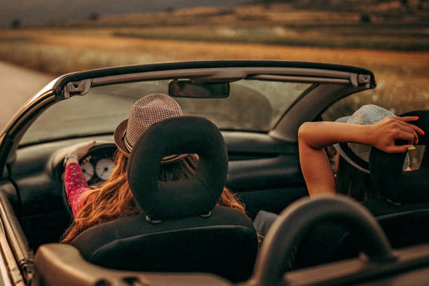 istock Girls enjoying ride in convertible 1165635107