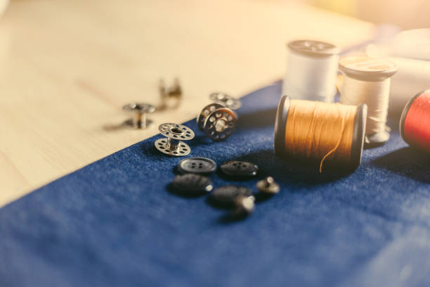 istock Accessories for tailoring on fabric and wooden top. 1165635140