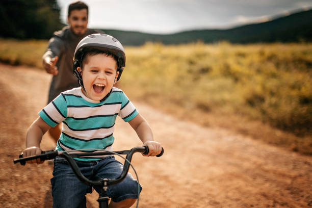 You are ready to go alone Father helping son to ride a bicycle dirt road photos stock pictures, royalty-free photos & images