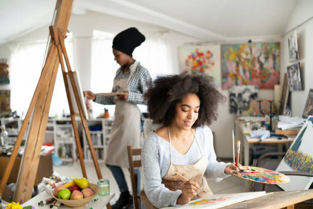 istock Female fine artists drawing in studio 1165643052